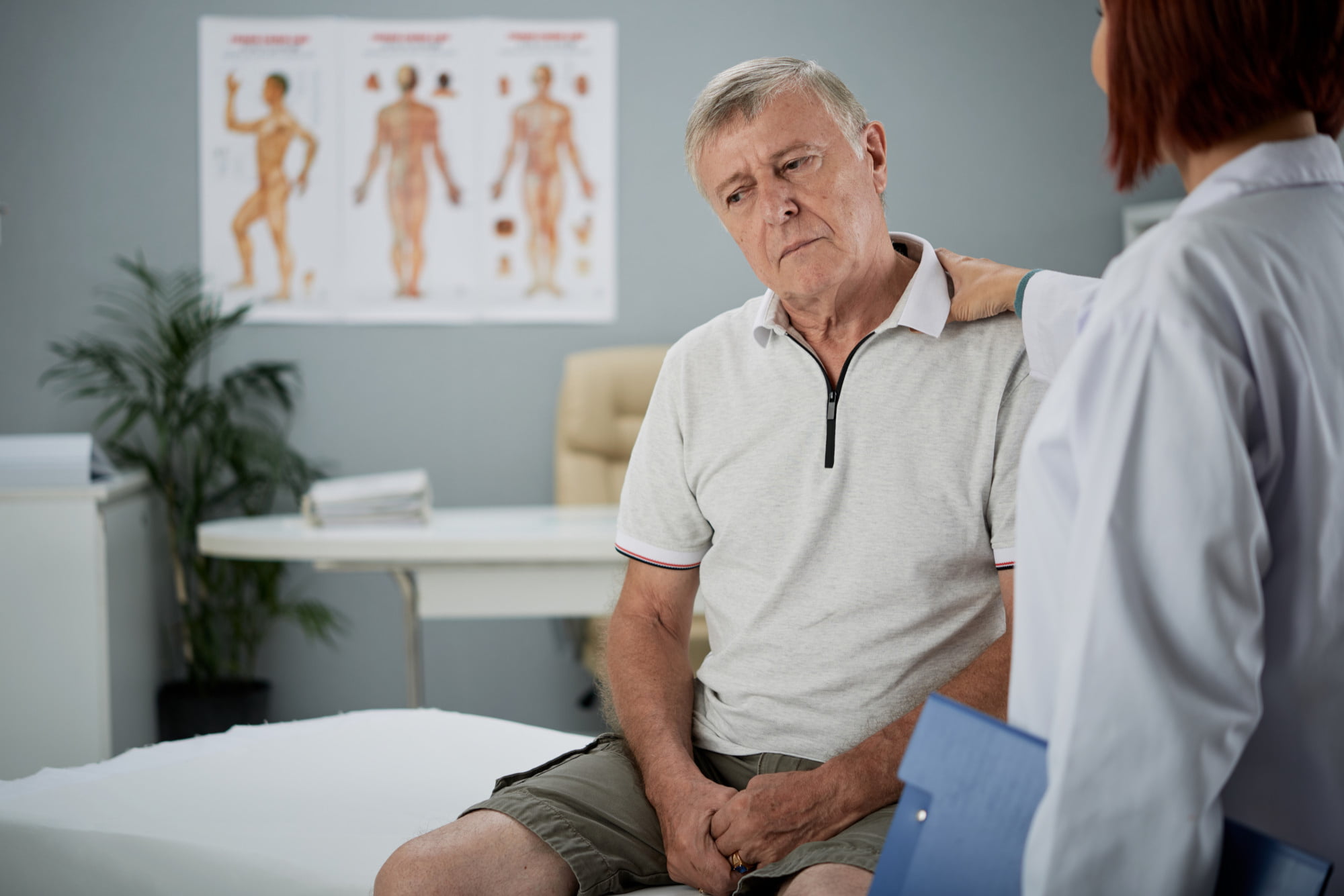 Médico conversando con un paciente mayor en el consultorio